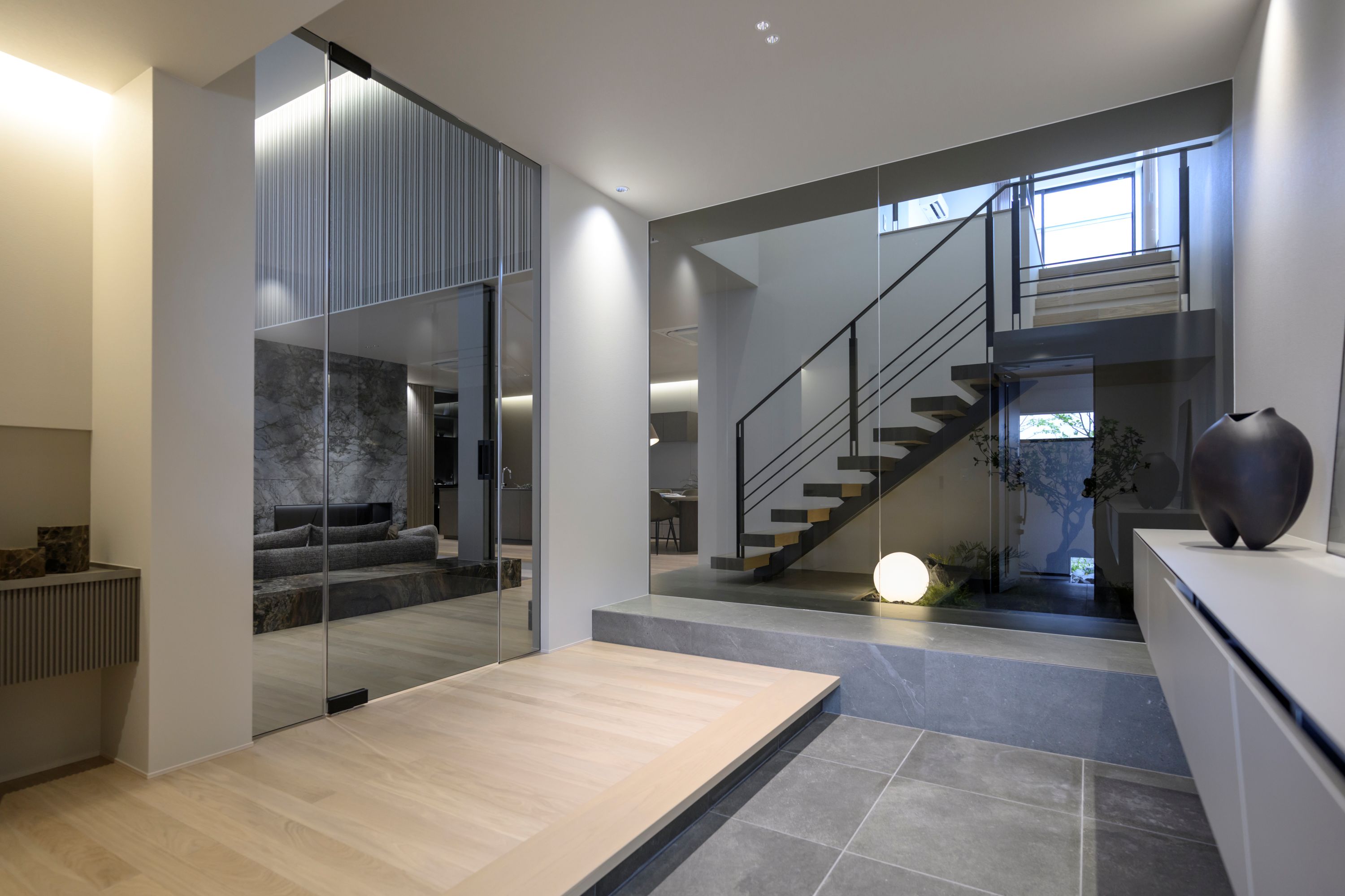 【玄関】ブラックガラスを採用した玄関ホール　造作階段が美しい